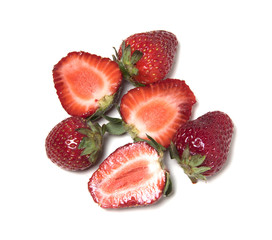 Strawberry. Three berries are cut in half and three berries are whole.
