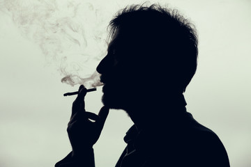 Man smoking a cigarette. Silhouette