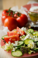 Tasty Greek salad with lettuce, cherry tomatoes and feta cheese