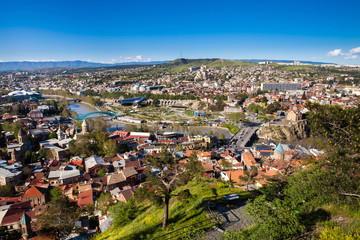 Fototapeta na wymiar Panorama of Tbilisi city, Georgia. Aerial cityscape view