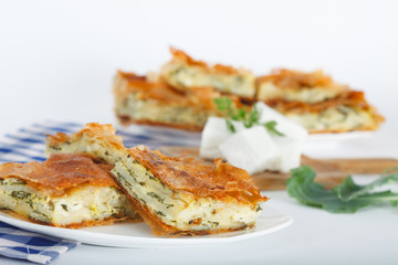 Delicious pie with spinach and feta cheese, traditional Greek, Serbian or Bulgarian cuisine.