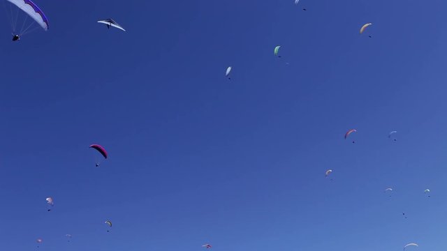 Background oh Flying paragliders in the blue sky