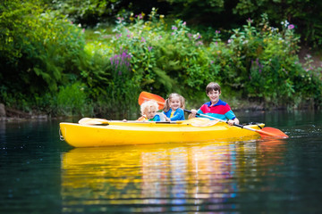 Kids kayaking on a river