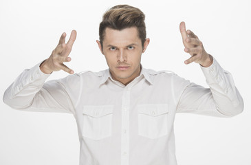 Naklejka premium Handsome young man making furious face, with hands on head, isolated on white