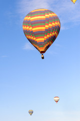 Many balloons over the extraordinary rocks formations rock hills in Cappadocia, Nevsehir, Turkey.