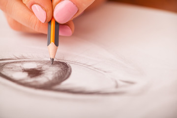 Closeup of drawing human eye at the desk