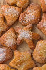 Cookies of different shapes with sugar for a Golden crust.