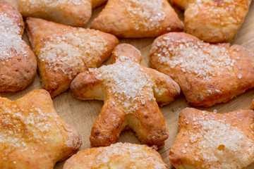 Cookies of different shapes with sugar for a Golden crust.