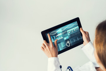 Close of female doctor hands working with tablet pc computer