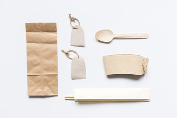 food delivery workdesk with paper bags and flatware table background top view mock-up