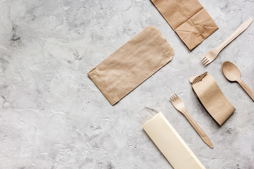 food delivery workdesk with paper bags and flatware table background top view mock-up