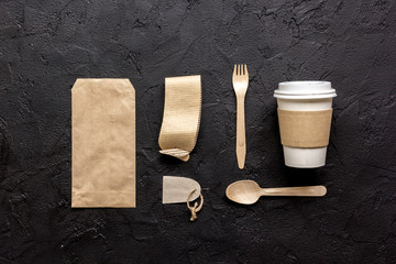 Fototapeta na wymiar food delivery with paper bags and plastic cup on dark table background top view mockup