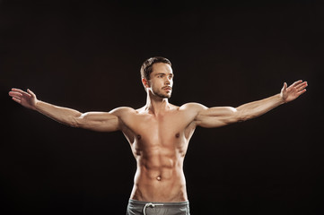 Fototapeta na wymiar Young man athlet muscle body portrait in gym