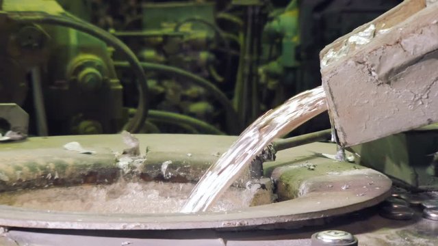 liquid aluminium is overflowing, close-up, in Metallurgical plant, Car factory