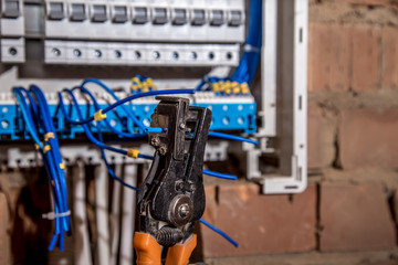 the Assembly of the electrical panel, electrician job, a robot with wires and circuit breakers