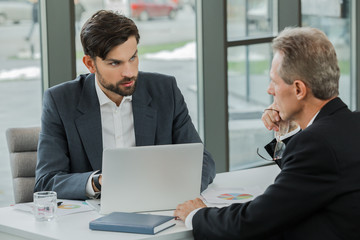 Stylish businessmen working in office