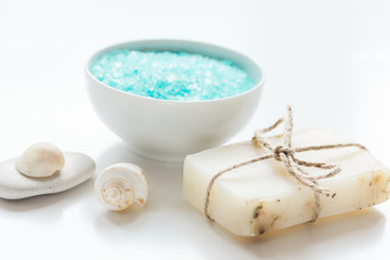spa composition with blue sea salt and natural soap on white desk background