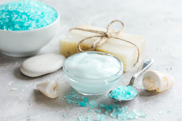 Obraz na płótnie Canvas Home cosmetic with cream and blue sea salt on stone background