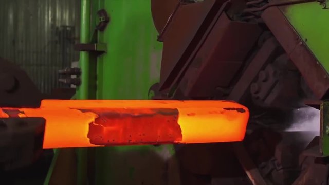 Manufacture of rails for trains and freight wagon, boxcars. Rail manufacturing plant. Stack of steel round bar - iron metal rail lines material for industry construction in warehouse. the big press