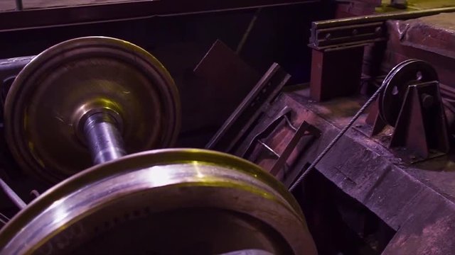 Manufacture of rails for trains and freight wagon, boxcars. Rail manufacturing plant. Stack of steel round bar - iron metal rail lines material for industry construction in warehouse. the big press