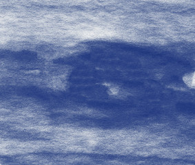 Abstract watercolor background hand painted on textured paper in blue shades