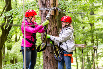Family  in high rope course or park climbing