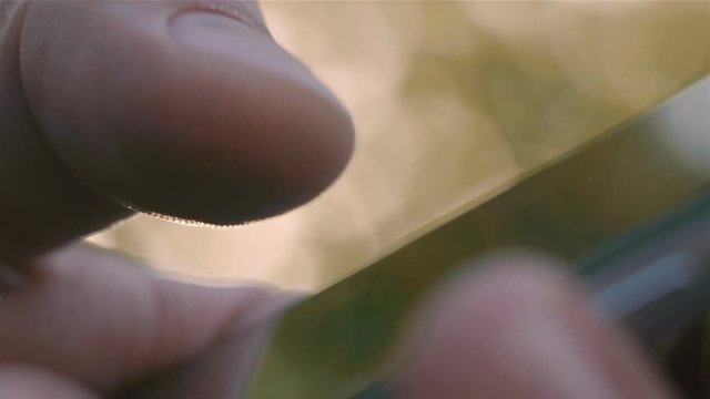 Closeup of young man hands typing sms scrolling pictures phone