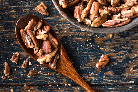 Chopped Pecans On A Wood Spoon