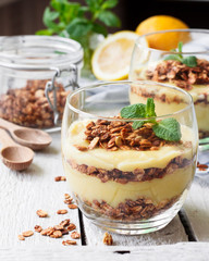 Healthy dessert in a glass with lemon cream and granola