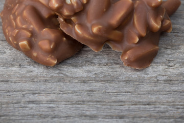 Special chocolate pieces on wooden background