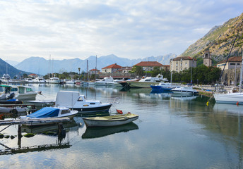 Fototapeta na wymiar Evening landscape with moored boats in Kotor Bay, Montenegro