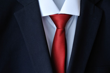 Stylish dark blue men's suit and red tie
