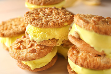 Delicious lemon ice cream cookie sandwiches on kitchen table, closeup