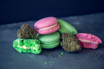 Marijuana Edibles With Cannabis Nugs On Dark Slate Background. Selective Focus With Copy Space.