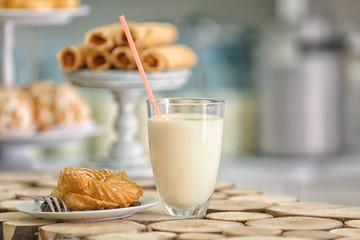 Plate with dessert and glass of milk on table