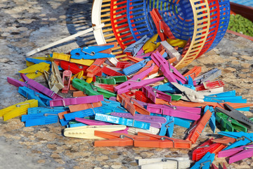 Clothespins. Colorful clothespin in the basket, stand on the table in the garden. Cloth clothespins.