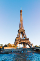 Fototapeta na wymiar Eiffel Tower over Seine river in soft sunset light, Paris, France