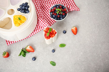 Composition with tasty yogurt and ingredients on kitchen table