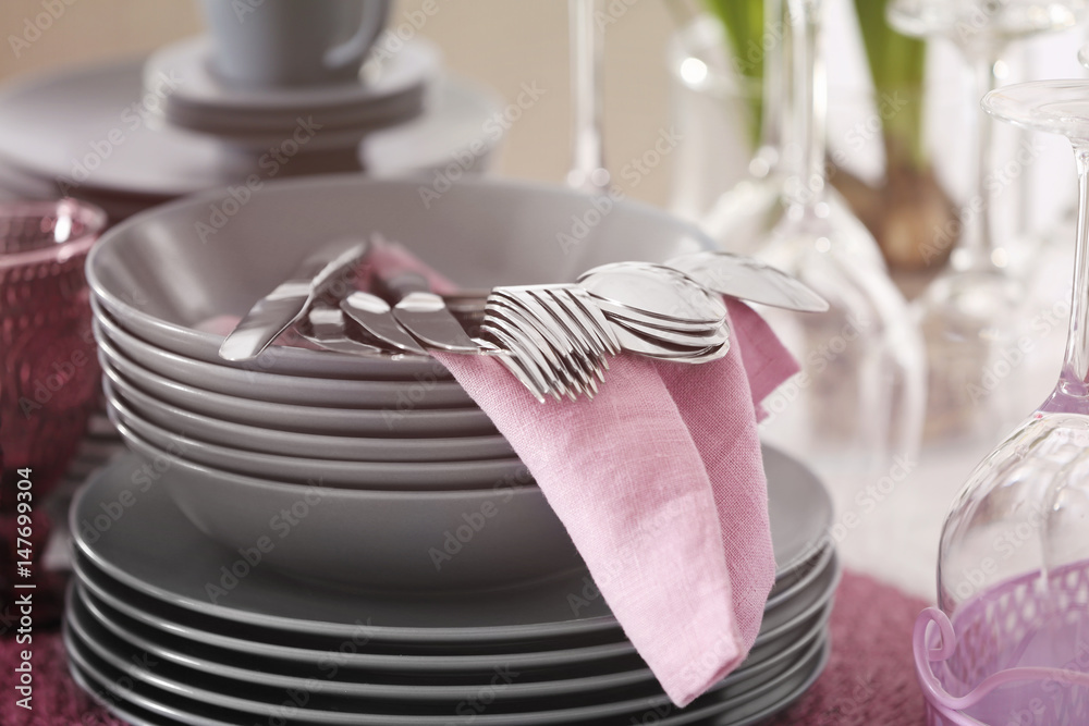 Poster Set of dishware and cutlery with lilac napkin, closeup