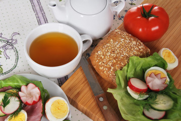 A tea made by grandma with a tasty sandwich