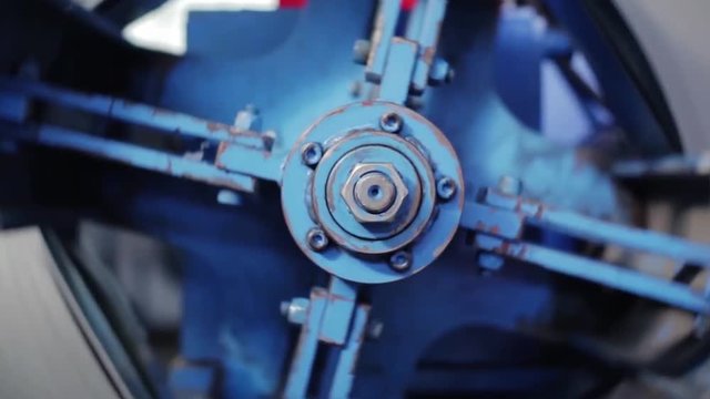 Big bolt. The rotating part of the machine. View of rotation machine in Printing house. Part of machine that is called the star, it changes rolls of paper continuously. manufacturing equipment