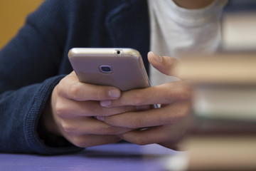 close-up of hands of the child with the mobile phone