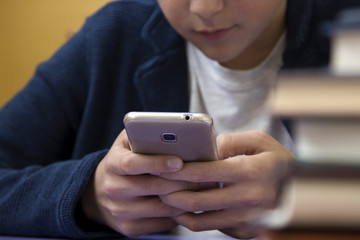 close-up of hands of the child with the mobile phone