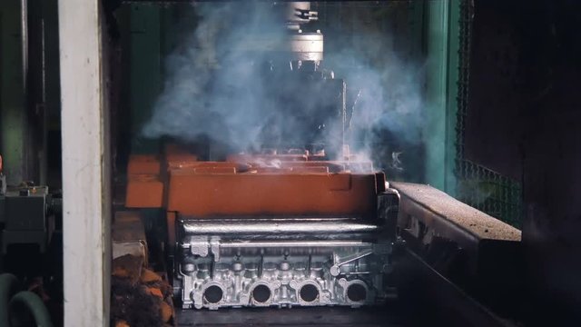 brand new car engines are cooling down in a car factory, and moving on a conveyor