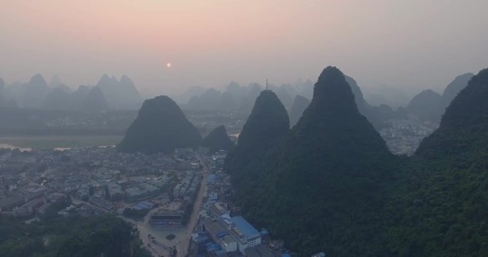 Top view of amaizing famous Yangshuo valley in Guilin, Guangxi, China. Aerial View of beautiful sunrise over Yulong or Dragon River in Yangshuo, China. Overpopulation concept, beauty in nature