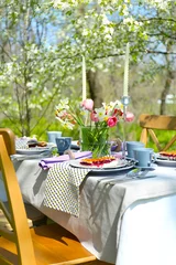 Foto op Canvas Table setting and cage with flowers in garden © Africa Studio