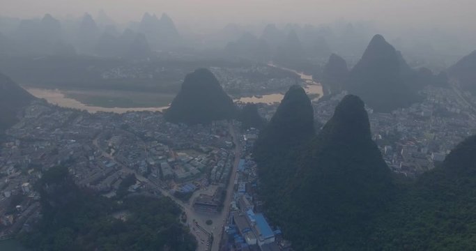 Top view of amaizing famous Yangshuo valley in Guilin, Guangxi, China. Aerial View of beautiful sunrise over Yulong or Dragon River in Yangshuo, China. Overpopulation concept, beauty in nature
