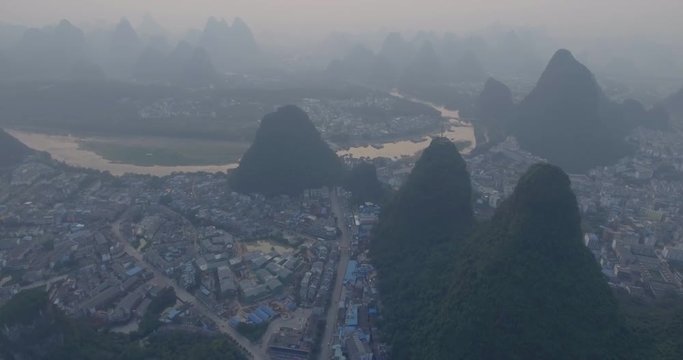 Top view of amaizing famous Yangshuo valley in Guilin, Guangxi, China. Aerial View of beautiful sunrise over Yulong or Dragon River in Yangshuo, China. Overpopulation concept, beauty in nature