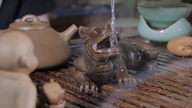 Traditional Chinese Tea Ceremony and pour the tea in a glass of the clay. Pouring Tea With The Help Of Ladle