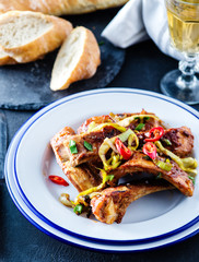 Roasted sliced barbecue pork ribs, seasoned with a spicy basting sauce and served with vegetables.